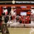 File photo of shoppers walking past a Manchester United merchandise store at a mall in Singapore