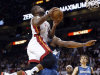 Miami Heat's Dwyane Wade, foreground, is fouled by Minnesota Timberwolves' Dante Cunningham as Wade goes to the basket during the half of an NBA basketball game Tuesday, Dec 18, 2012, in Miami. (AP Photo/Alan Diaz)