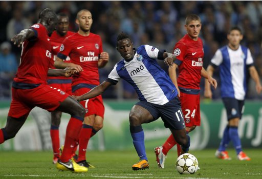 Porto's Varela is challenged during Champions League Group A soccer match against Paris Saint German at the Dragon stadium in Porto