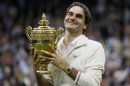 Roger Federer of Switzerland holds the winners trophy after defeating Andy Murray of Britain in their men's final tennis match at the Wimbledon Tennis Championships in London