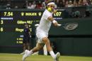 Roger Federer of Switzerland plays a return to Gilles Muller of Luxembourg during their men's singles match at the All England Lawn Tennis Championships in Wimbledon, London, Thursday, June 26, 2014. (AP Photo/Sang Tan)