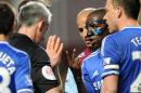 Chelsea's Ramires, right, appeals to referee Christopher Foy about an earlier yellow card during the English Premier League soccer match between Aston Villa and Chelsea at Villa Park, Birmingham, England, Saturday, March 15, 2014. (AP Photo/Rui Vieira)