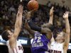 Western Carolina's Harouna Mutombo (22) shoots over Davidson's JP Kuhlman, left, and Nik Cochran, right, during the first half of an NCAA college basketball game for the Southern Conference men's tournament title Monday, March 5, 2012, in Asheville, N.C. (AP Photo/Bob Leverone)