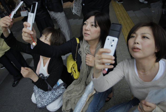 Visitors take photos of the Tokyo Skytree at its grand opening in Tokyo, Tuesday, May 22, 2012. The world's tallest tower and Japan's biggest new landmark opened to the public on Tuesday. (AP Photo/It