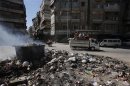 Smoke clears up after residents burn rubbish at the center of Aleppo city
