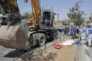 The body of a driver of a construction vehicle lies covered at the scene of a an attack in Jerusalem