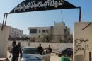 Rebel fighters at an entrance of the Aleppo headquarters of the Islamic State of Iraq and the Levant (ISIL), a rival rebel group former Australian solider Caner Temal is believed to have fought with