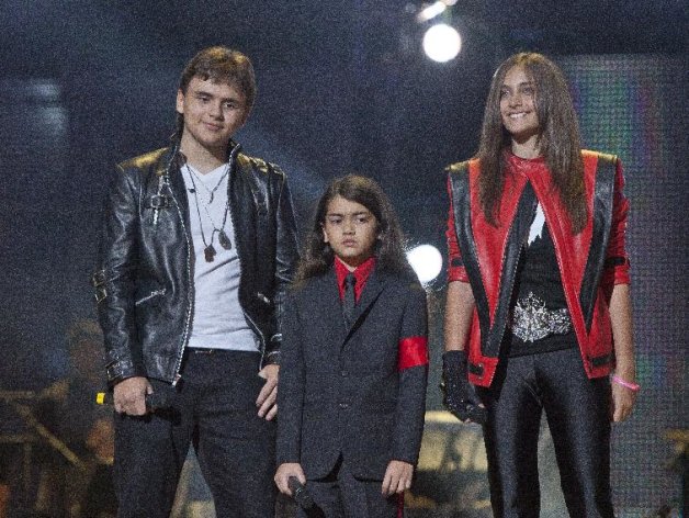 FILE - In this Oct. 8, 2011 file photo, from left, Prince Jackson, Prince Michael II "Blanket"Jackson and Paris Jackson arrive on stage at the Michael Forever the Tribute Concert, at the Millennium Stadium in Cardiff, Wales. Jurors hearing a civil case in Los Angeles filed by Jackson’s mother, Katherine Jackson, have heard numerous stories about the entertainer’s devotion to his children as expressed through extravagant birthday parties and secret family outings. The tender moments have been described throughout the trial, which concluded its eighth week on Friday, June 21, 2013. (AP Photo/Joel Ryan, file) *Editorial Use Only*