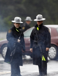 Pennsylvania State Police troopers man a roadblock Sunday, Aug. 28, 2011, in Furlong, Pa. A soldier who recently returned from war service fired at officers in suburban Philadelphia as he was sought in the Virginia deaths of his ex-wife, her boyfriend and the boyfriend's young son, authorities said. The soldier's former mother-in-law was also killed, and he remains at large. Residents of Warwick Township, Pa. were asked to stay in their homes and lock doors and cars as police hunted for Leonard John Egland, 37, of Fort Lee, Va., who evaded authorities as Hurricane Irene lashed the area. (AP Photo/Matt Rourke)