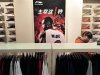 Customer shops at a Li Ning sportswear store in front of a poster of NBA basketball player Dwyane Wade in Shenyang
