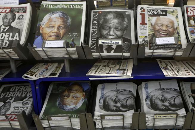 Newspapers with pictures of Nelson Mandela on the front page are on sale at a newsagent in London, Friday, Dec. 6, 2013. Mandela passed away Thursday night after a long illness. He was 95. As word of Mandela's death spread, current and former presidents, athletes and entertainers, and people around the world spoke about the life and legacy of the former South African leader. (AP Photo/Sang Tan)