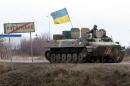 A tank crew displaying the Ukrainian flag near the eastern town of Luganske in the Donetsk region on February 8, 2015