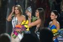 The Miss Universe crown is removed from Miss Colombia Ariadna Gutierrez (L) by 2014 winner Paulina Vega (C) after the pageant's host misread the cue card stating Miss Philippines Pia Alonzo Wurtzbach (R) as the winner on December 20, 2015