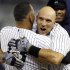 New York Yankees' Alex Rodriguez, left, embraces Raul Ibanez after Ibanez hit a 12th inning, walk-off RBI single to give the Yankees a 4-3 win in their baseball game against the Boston Red Sox at Yankee Stadium in New York, Tuesday, Oct. 2, 2012. (AP Photo/Kathy Willens)