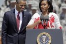 First lady Michelle Obama introduces President Barack Obama at the Fort Stewart Army post, Friday, April 27, 2012, in Fort Stewart, Ga. (AP Photo/David Goldman)
