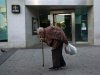 An elderly man walks past a branch of Spain's lender bank Bankia in Madrid