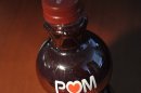 A photo illustration of a bottle of POM Wonderful pomegranate juice