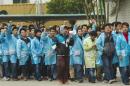 IBM workers shout slogans as they protest at an IBM factory in Shenzhen