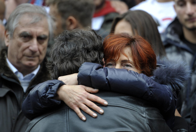 Rossella, mother of late MotoGP rider Marco Simoncelli, is comforted by an unidentified man at the end of the funeral service outside the Santa Maria church in Coriano, Italy, Thursday, Oct. 27, 2011.