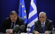 Greek Finance Minister Evangelos Venizelos (left) and Greek Prime Ministers Lucas Papademaos give a joint press after their Eurogroup Council meeting at EU headquarters in Brussels. Europe opted to keep Greece in the eurozone, agreeing a huge financial lifeline worth 237 billion euros but demanding Athens meet a long list of conditions first.