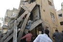 Men search for survivors amid the rubble of collapsed buildings at a site hit by what activists say was a car bomb in Raqqa province
