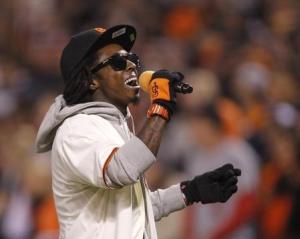 Rapper Lil Wayne sings during the seventh inning stretch in Game 6  of the MLB NLCS playoff baseball series between the St. Louis Cardinals and the San Francisco Giants in San Francisco
