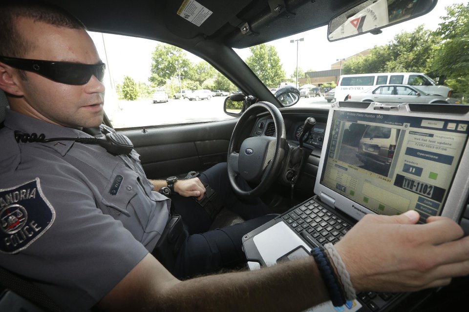 Office Dennis Vafier of the Alexandria Police Dept., uses a laptop in his squad car to scan vehicle license plates during his patrols, Tuesday, July 16, 2013 in Alexandria, Va. Local police departments across the country have amassed millions of digital records on the location and movements of vehicles with a license plate using automated scanners. Affixed to police cars, bridges or buildings, the scanners capture images of passing or parked vehicles and note their location, dumping that information into police databases. Departments keep the records for weeks or even years. (AP Photo/Pablo Martinez Monsivais)