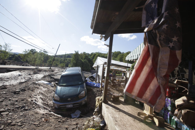 A car lies in a ditch in front of the Country Store a after being dragged by the Batavia Kill stream after Tropical Storm Irene flooded parts of the town, Tuesday, Aug. 30, 2011 in Windham, N.Y. Offic