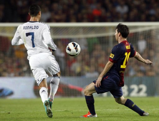 Barcelona's Messi and Real Madrid's Ronaldo fight for the ball during their Spanish first division soccer match at Nou Camp stadium in Barcelona
