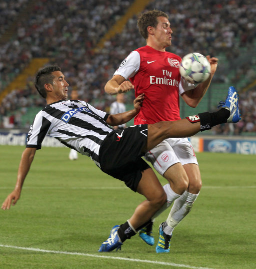 Udinese's midfielder Giampiero Pinzi, left, and Arsenal's midfielder Aaron Ramsey challenge for the ball during their Champions League qualifying playoff second leg soccer match in Udine, Italy, Wednesday, Aug. 24, 2011. Arsenal won 2-1 and advances 3-1 on aggregate. (AP Photo/Paolo Giovannini)