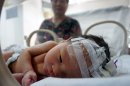 In this Tuesday, May 28, 2013 photo, the baby who was rescued after being trapped in a sewage pipe moments after his birth, lies in an incubator at a hospital in Pujiang county in east China's Zhejiang province. The newborn has been released from the hospital into the care of his grandparents. Local officials and media reports said Thursday, May 30, 20123, that authorities have concluded it was an accident, meaning his unwed mother is unlikely to be criminally charged. (AP Photo) CHINA OUT