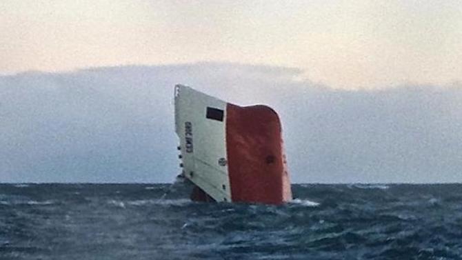 The upturned hull of cargo vessel Cemfjord pictured in the sea 15 miles from Wick in northeast Scotland on January 3, 2015