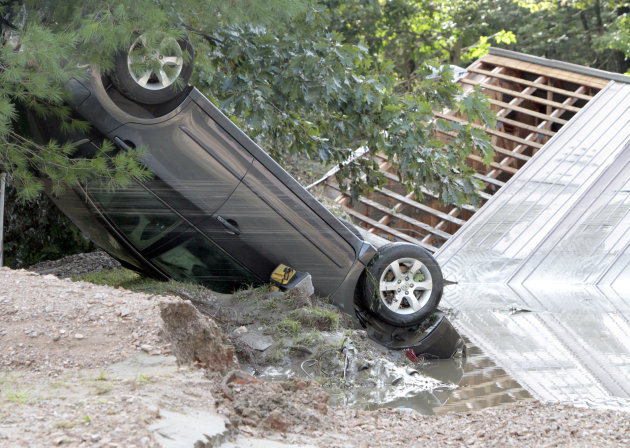 A car lies upside down in the aftermath of Tropical Storm Irene on Monday, Aug. 29, 2011 in Waterbury, Vt. (AP Photo/Toby Talbot)