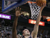 San Antonio Spurs guard Manu Ginobili (20), of Argentina, scores against Utah Jazz center Al Jefferson (25) during the first half of Game 3 in their first-round NBA basketball playoff series, Saturday, May 5, 2012, in Salt Lake City. (AP Photo/Colin E Braley)