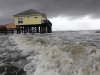 Squalls and heavy surf pounds homes along the beach in Dauphin Island, Ala., Monday, Sept.  5, 2011. The heavy waves were breaking under homes, damaging underpinnings and ripping porches and steps from the structures. Tropical Storm Lee is moving inland along the Gulf Coast bringing torrential rains and flooding. (AP Photo/Dave Martin)
