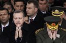 File photo of Turkey's PM Erdogan and Chief of Staff General Basbug praying during a funeral in Ankara