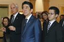 Japanese Prime Minister Shinzo Abe, center, tours the John F. Kennedy Presidential Library in Boston, with Edwin Schlossberg, second from left, and Caroline Kennedy, background right, Sunday, April 26, 2015. (AP Photo/Michael Dwyer)