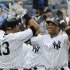 New York Yankees' Robinson Cano, right, celebrates with Alex Rodriguez, left, after Cano hit a grand slam during the fifth inning of a baseball game against the Oakland Athletics Thursday, Aug. 25, 2011 at Yankee Stadium in New York. (AP Photo/Bill Kostroun)