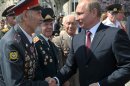 Russian President Vladimir Putin, right, greets World War II veterans before an opening ceremony of newly built fountain called Children Dancing in the southern Russian city of Volgograd, once known as Stalingrad, Friday, Aug. 23, 2013. The fountain is a replica of a fountain which miraculously survived in heavy bombing in Stalingrad in 1942. The original fountain survived until 1951. This year Russia celebrated the 70th anniversary of the end of one of modern warfare's bloodiest battles (in Stalingrad) that was turning point in World War II and led to the defeat of the Nazi Germany. (AP Photo/RIA-Novosti, Alexei Nikolsky, Presidential Press Service)