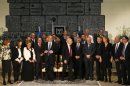 Israel's President Peres and Prime Minister Netanyahu stand up after posing for a group photo together with the ministers of the new Israeli parliament, in Jerusalem