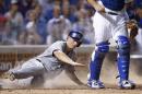 Colorado Rockies' DJ LeMahieu scores past Chicago Cubs catcher Kyle Schwarber as Corey Dickerson grounds out to first during the fifth inning of a baseball game in Chicago, Tuesday, July 28, 2015. (AP Photo/Andrew A. Nelles)