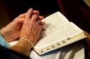 A worshipper holds a Bible during a church service on July 22, 2012 in Aurora, Colorado