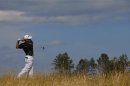 Louis Oosthuizen of South Africa watches his tee shot on the sixth hole during the first round of the British Open golf Championship at Muirfield in Scotland
