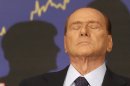FILE - In this Sept. 27, 2012 file photo, Italian former premier Silvio Berlusconi reacts during a press conference in Rome, Italy. A court in Italy has convicted, Friday, Oct. 26, 2012, former Premier Silvio Berlusconi of tax fraud and sentenced him to four years in prison. In Italy, cases must pass two levels of appeal before the verdicts are final. Berlusconi is expected to appeal. (AP Photo/Alessandra Tarantino, File)