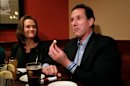 Republican presidential candidate, former Pennsylvania Sen. Rick Santorum, right, joined by his wife, Karen, eats cheese curds at a restaurant in West Bend, Wis., Sunday, April 1, 2012. (AP Photo/Jae C. Hong)