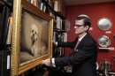 In this Wednesday, Feb. 29, 2012 photo, William Secord, president of William Secord Gallery, straightens a painting of his dog Rocky, in the office of his New York gallery. The William Secord Gallery in Manhattan is the only gallery in the nation dedicated exclusively to dog art. 