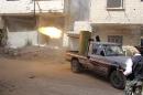 A rebel fighter fires during clashes with Syrian forces in eastern al-Ghouta, near Damascus