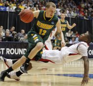 Vermont guard Sandro Carissimo (12) drives past Lamar guard Devon Lamb during the second half of an NCAA first-round college basketball tournament game, Wednesday, March 14, 2012, in Dayton, Ohio. Vermont won 71-59. (AP Photo/Skip Peterson)
