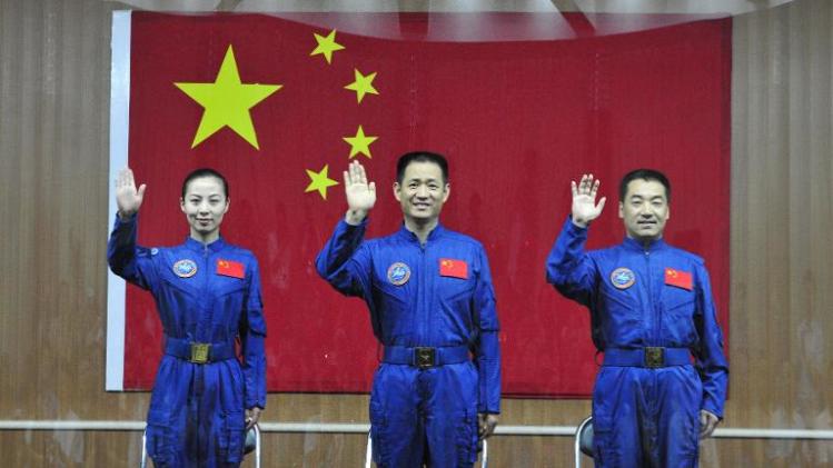 Image taken on June 10, 2013 shows crew members of Shenzhou-10 (L-R) Wang Yaping, Nie Haisheng and Zhang Xiaoguang at a press conference in Jiuquan, China