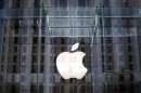 The Apple logo hangs inside the glass entrance to the Apple Store on 5th Avenue in New York City,